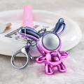 Detail of creative iridescent rabbit keychain with pink strap and silver metal clasp - Purple