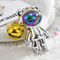 Cute acrylic astronaut bear keychain with rainbow visor and golden bell on plush background - Bear Pendant with Large Bell / White