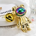 Golden astronaut bear keychain with iridescent visor and bell on plush background - Bear Pendant with Large Bell / Gold