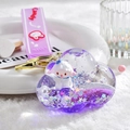 Macro detail of cloud-shaped liquid quicksand keychain with purple glitter and cartoon sheep - Purple
