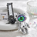 Detail of silver astronaut keychain with rainbow visor and Dream On rubber strap - White