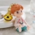 Cute boy figurine keychain in pink panda hoodie with large golden bell accessory - Pink Boy Pendant