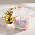 Porte-clés sac à dos en acrylique avec perles macarons colorées et clochette dorée - Blanc