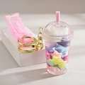 Close-up of a bubble tea cup keychain with pastel stars and pink silicone strap - Pentagram Series