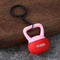 Close-up of a pink and red silicone kettlebell keychain with YOGA text and metal ring - Yoga Kettlebell-Red