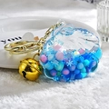 Shell-shaped liquid acrylic keychain in light blue with glitter and golden bell - Candy Bead Bell Style (Blue)