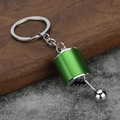 Close-up of a green manual gear shifter keychain model with movable silver lever - Green