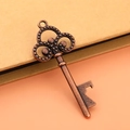 Vintage copper-plated key bottle opener accessory on a brown kraft gift box background - Antique Red