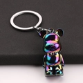 Macro shot of iridescent gradient bear keychain with polished silver metal link ring - Iridescent