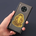 Detailed golden Buddhist Bodhisattva metal sticker on the back of a black smartphone - Vairocana - Sheep and Monkey Zodiac