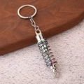 Macro shot of silver car shock absorber keychain with colorful electroplated spring - Iridescent