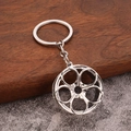 Polished silver alloy car rim keychain with five-spoke wheel pendant on wooden background - White K/Silver