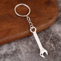 Close-up of industrial style silver metal wrench keychain with hex hole and link chain - Wrench Style 2