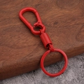 Detail of red metal spring keychain showing the durable carabiner and glossy finish - Red