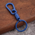Detail view of electric blue spring car keychain with high-quality metal carabiner hook - Blue