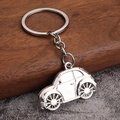 Detailed close-up of a silver beetle car keychain with a polished metallic finish - White K/Silver