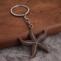 Vintage bronze starfish pendant keychain with textured relief on silver keyring - Antique Red