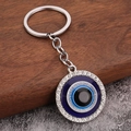 Close-up of blue evil eye owl keychain with sparkling rhinestones on wood base - Silver Rhinestone Evil Eye (H-0301)