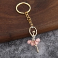 Portachiavi ballerina con cristalli rosa e montatura in lega d'oro su fondo in pietra - Rosa Chiaro