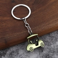Macro detail of a vintage bronze golf cart keychain with realistic 3D zinc alloy texture - Bronze