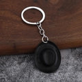 Detail of creative bronze western cowboy hat keychain with metallic texture and ring - Black