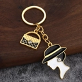 Goldener Emaille Schlüsselanhänger mit gesteppter Handtasche und elegantem Damen-Silhouette - Gold