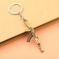 Portachiavi modello di arma AK-47 in lega di bronzo antico su sfondo bicolore minimalista - Bronzo Antico