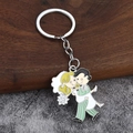 Détail du porte-clés de mariage en émail montrant un marié portant sa mariée en dessin - Style Marié Portant la Mariée dans ses Bras (009)