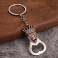 Close-up of antique bronze lion head bottle opener keychain with crown detail on wood - Lion Design - Antique Red