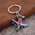 Realistic colorful metal airplane keychain with vibrant electroplated rainbow finish - Iridescent