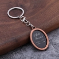 Macro detail of antique bronze oval photo frame keychain with photo insert measurements - Antique Red
