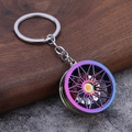 Auto-Bremsscheiben-Schlüsselanhänger mit Regenbogen-Finish und rotem Bremssattel auf Holz - Irisierend
