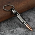 Bullet-shaped metal bottle opener keychain in gun grey finish on rustic background - Gun Black