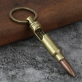 Macro detail of bullet shaped bottle opener keychain on a rustic wooden texture - Bronze