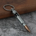 Macro detail of bullet shaped bottle opener keychain with vintage metal texture - Antique Pewter