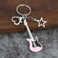 Close-up of guitar keychain with pink enamel, star charm and heart-shaped lobster clasp - Small Hollow / Pink