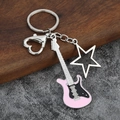 Detail of a pink electric guitar keychain with a hollow star pendant and heart clasp - Large Hollow / Pink