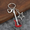 Detailed view of musical electric guitar keychain with star charm and heart clasp - Large Hollow / Red