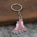 Detailed view of pink zinc alloy quad roller skate keychain with silver metal ring - Rose Red