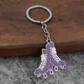 Detailed view of two purple roller skate pendants with silver chain and keyring - Purple