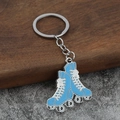 Detail shot of a blue retro roller skate keychain with metal chain on wood texture - Sky Blue
