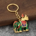 Gedetailleerde opname van Thaise olifant sleutelhanger met groen email en gouden ring - Groen