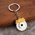 Detail of yellow brake caliper and metal disc rotor keychain with premium silver chain - Yellow