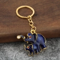 Portachiavi a forma di elefante in smalto blu con bordi dorati e charm in metallo - Blu