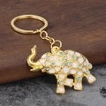 Detailed macro view of golden elephant keychain with white and blue enamel dots - Sky Blue
