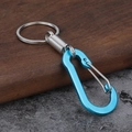Blue D-ring aluminum carabiner keychain with silver spring coil on a dark textured surface - Sky Blue Square Style