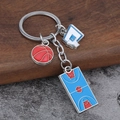 Detail of a basketball keychain with metal hoop, red basketball, and blue court charms - Basketball