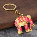 Makroaufnahme von thailändischem Elefanten-Schlüsselanhänger mit rosa Emaille und Gold - Rosa