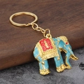 Detailed view of Southeast Asian style elephant keychain with blue and gold enamel finish - Sky Blue