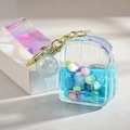 Porte-clés sac à dos en acrylique avec liquide bleu et perles pastel colorées - Style Corde Bonbons Bleu